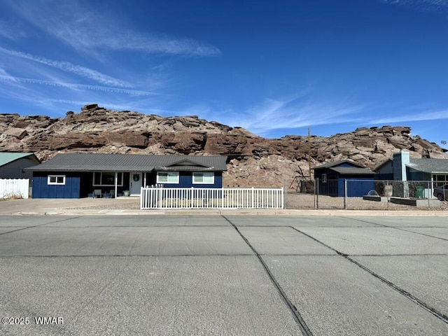 view of front of house featuring fence