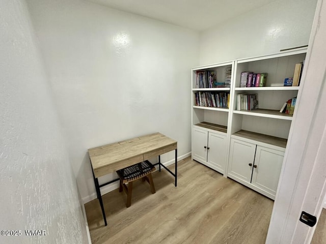 home office featuring light wood-type flooring and baseboards