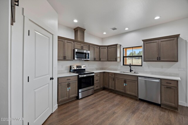 7141 Pair O Dice Rd, Show Low, AZ 85902 - kitchen with appliances with stainless steel finishes, a sink, light countertops, dark wood-style flooring, and recessed lighting