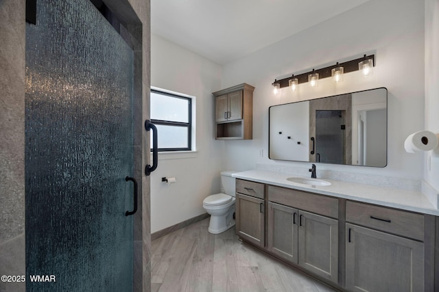 7141 Pair O Dice Rd, Show Low, AZ 85902 - full bathroom featuring a shower stall, vanity, wood finished floors, toilet, and baseboards