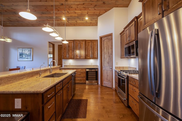 kitchen with beverage cooler, dark wood finished floors, brown cabinets, stainless steel appliances, and a sink