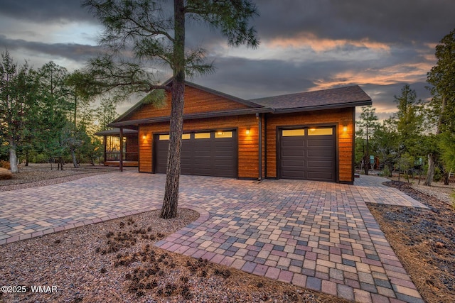 view of front facade featuring decorative driveway and a garage