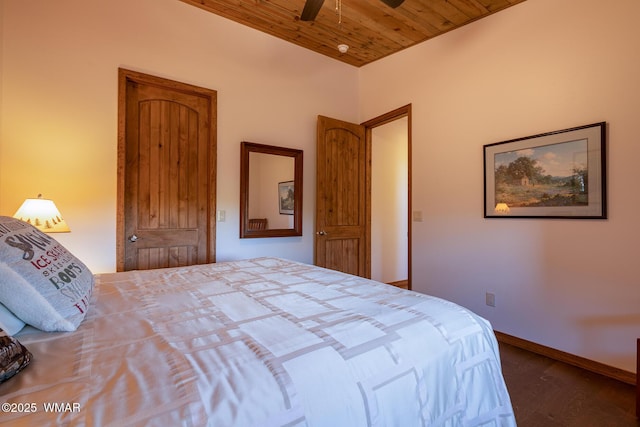 bedroom featuring wood finished floors, baseboards, wooden ceiling, and a ceiling fan