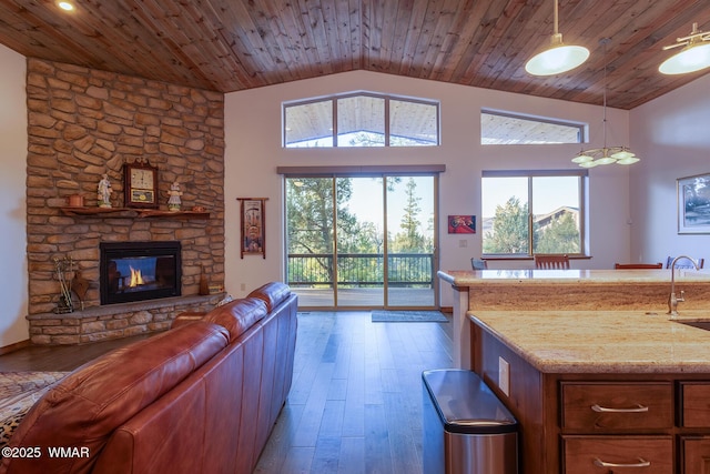 living area with vaulted ceiling, wood finished floors, and wood ceiling