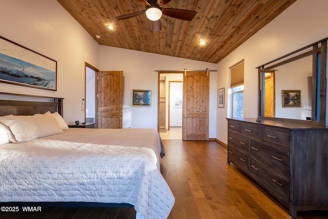 bedroom with wood ceiling, lofted ceiling, a barn door, recessed lighting, and wood finished floors