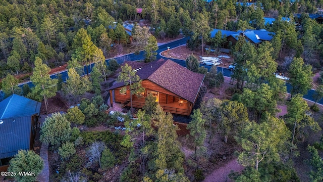 birds eye view of property with a view of trees