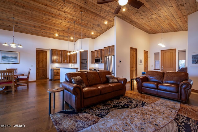 living room with dark wood-type flooring, a ceiling fan, recessed lighting, a high ceiling, and wood ceiling