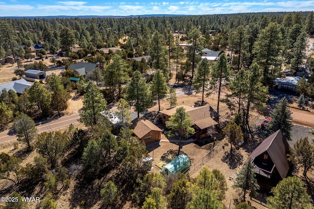 drone / aerial view featuring a forest view