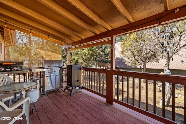 wooden deck featuring a grill