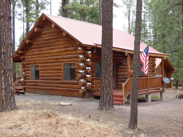 30 County Road 2066, Alpine, AZ 85920 - rear view of house with metal roof, covered porch, and log exterior
