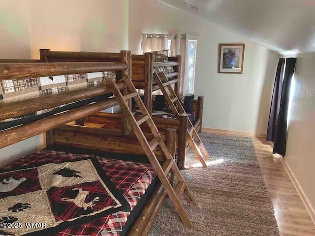 interior space featuring lofted ceiling and wood finished floors