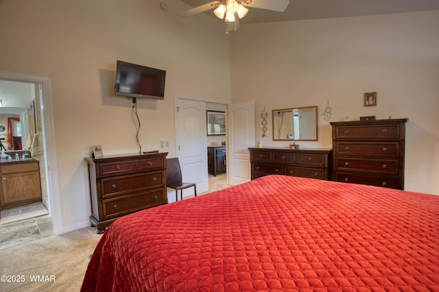 6646 Broken Arrow Way, Show Low, AZ 85901 - bedroom featuring a high ceiling, light carpet, connected bathroom, and a ceiling fan