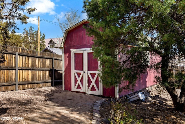 view of shed with a fenced backyard