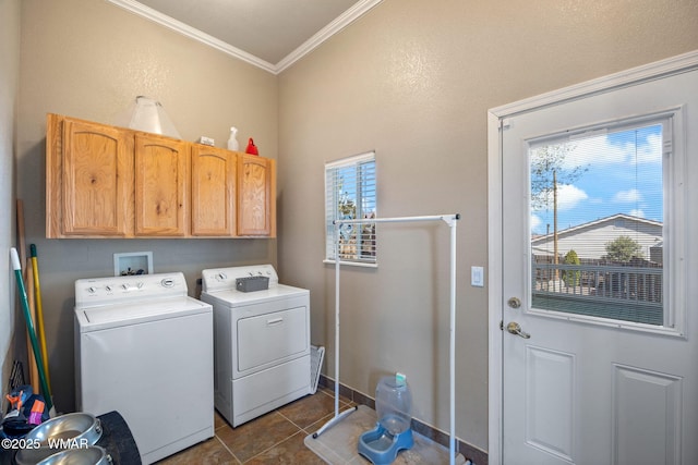 clothes washing area featuring ornamental molding, washer and dryer, baseboards, dark tile patterned floors, and cabinet space