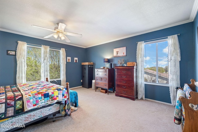 bedroom with crown molding, carpet floors, baseboards, and a ceiling fan