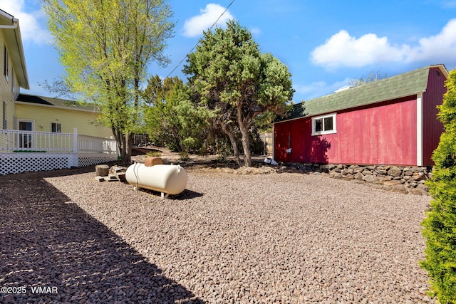 view of yard with a wooden deck and an outdoor structure