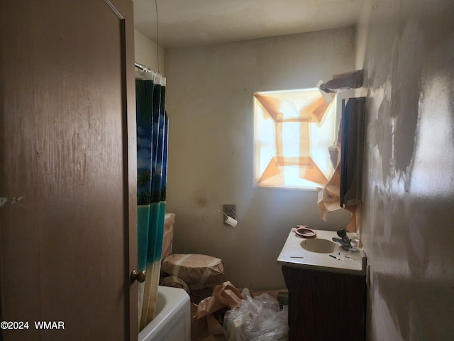 bathroom featuring shower / bath combo and vanity