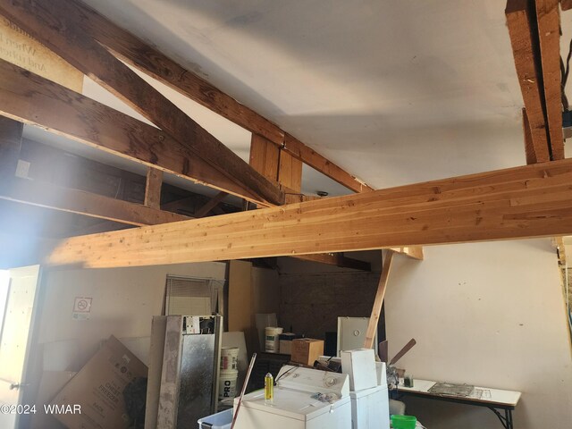 interior space featuring beamed ceiling and washer and dryer