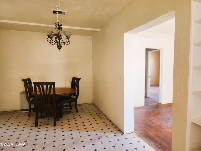 dining area with visible vents and an inviting chandelier