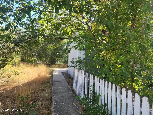 view of side of property featuring fence