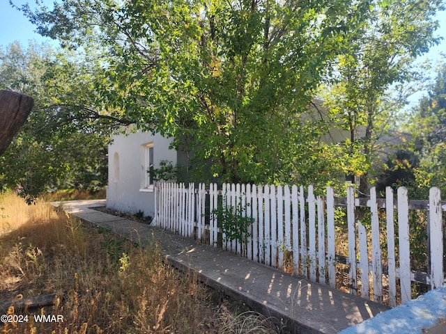 240 S 1st, Saint Johns, AZ 85936 - view of side of home with fence and stucco siding