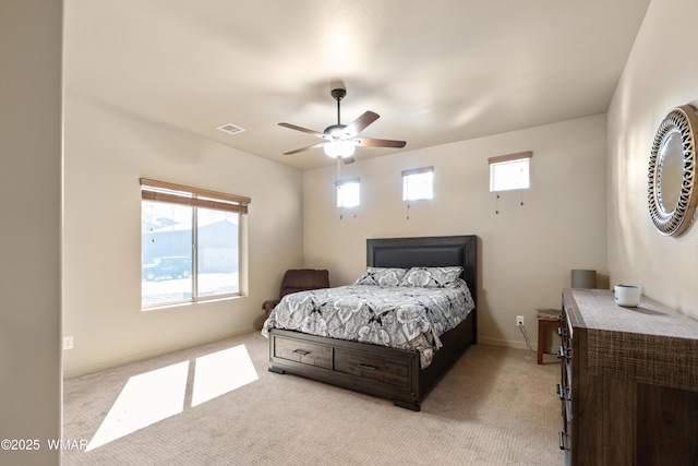 bedroom featuring light carpet, baseboards, visible vents, and a ceiling fan