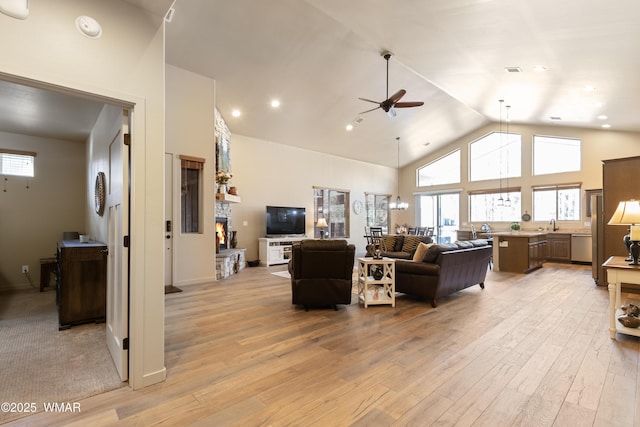 living room with high vaulted ceiling, light wood finished floors, a wealth of natural light, and a ceiling fan