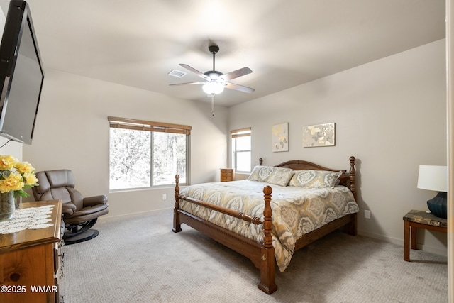 bedroom featuring baseboards, a ceiling fan, visible vents, and light colored carpet