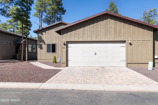 view of front facade with a garage and decorative driveway