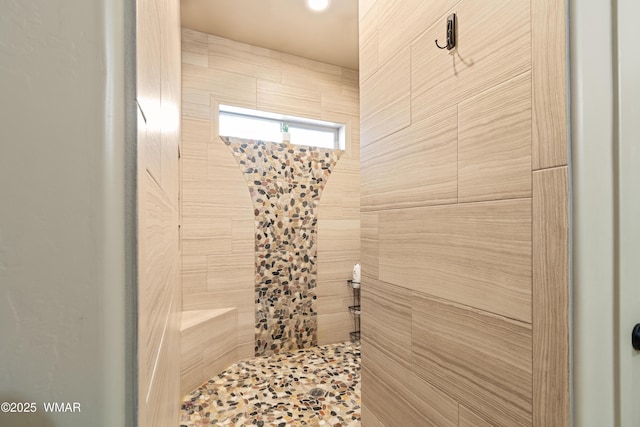 full bath featuring a tile shower