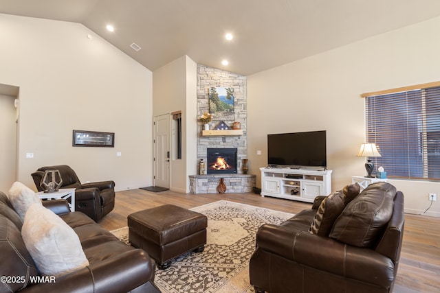 living room with high vaulted ceiling, recessed lighting, a fireplace, wood finished floors, and visible vents