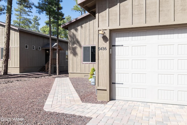 garage with decorative driveway