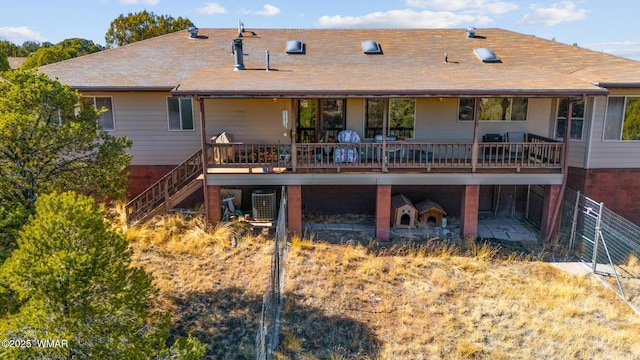 rear view of property featuring stairs, central AC, and a wooden deck