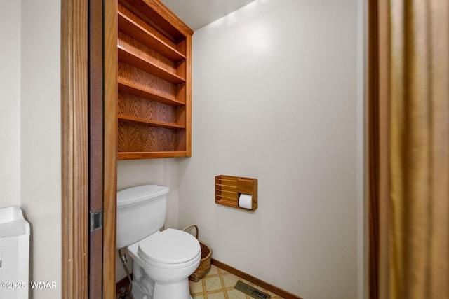 bathroom with toilet, baseboards, visible vents, and tile patterned floors