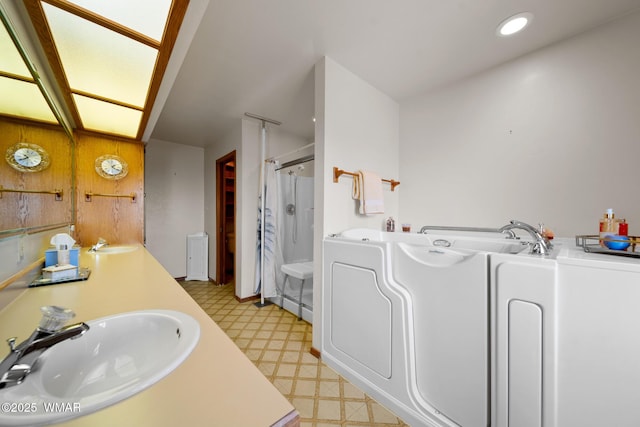 full bathroom featuring curtained shower, a sink, a bath, and tile patterned floors