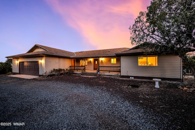 single story home with gravel driveway and an attached garage