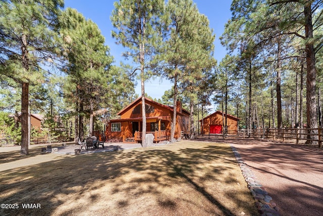 2722 Covered Wagon Trl, Overgaard, AZ 85933 - view of front of property with faux log siding and a barn