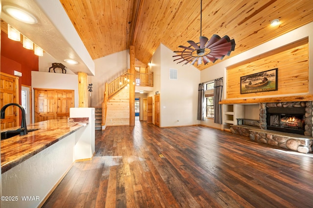 2722 Covered Wagon Trl, Overgaard, AZ 85933 - unfurnished living room featuring stairs, a stone fireplace, high vaulted ceiling, hardwood / wood-style floors, and wood ceiling