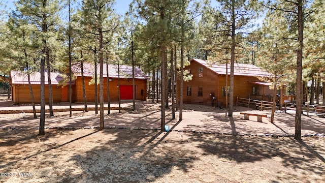 2722 Covered Wagon Trl, Overgaard, AZ 85933 - rear view of property featuring log veneer siding and a metal roof