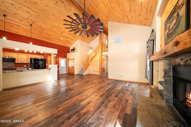 2722 Covered Wagon Trl, Overgaard, AZ 85933 - unfurnished living room with stairway, dark wood-type flooring, wood ceiling, high vaulted ceiling, and a stone fireplace