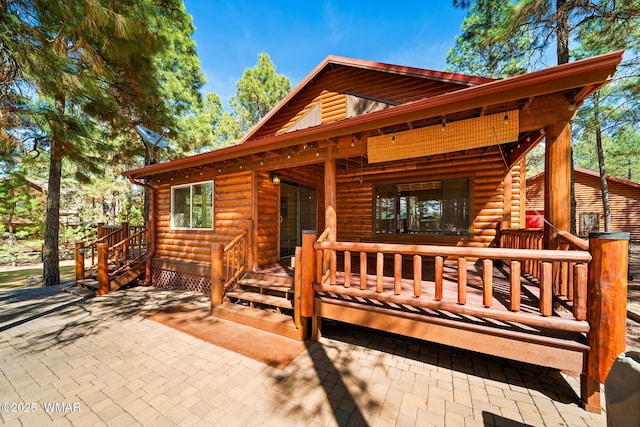 2722 Covered Wagon Trl, Overgaard, AZ 85933 - view of front of house with faux log siding and a porch