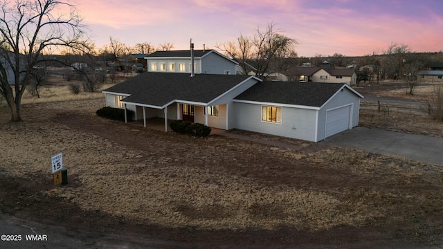 view of front of house with concrete driveway and an attached garage