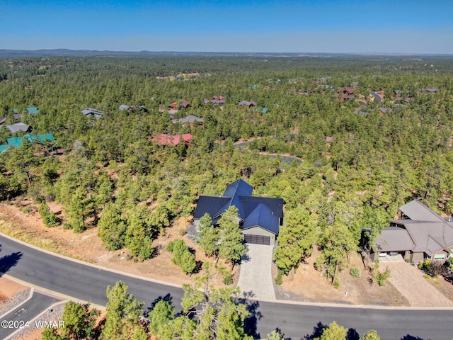 drone / aerial view with a wooded view