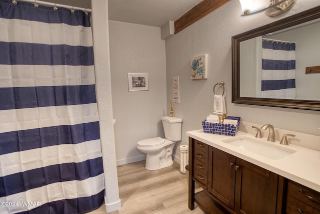 full bathroom with vanity, a shower with shower curtain, wood finished floors, and toilet