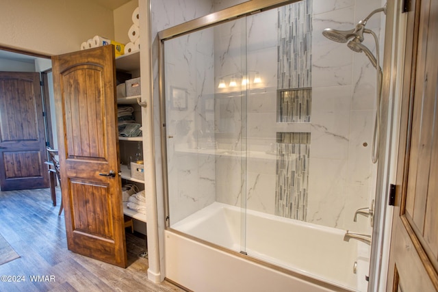 full bathroom featuring shower / bath combination with glass door and wood finished floors