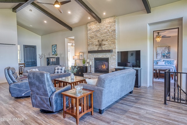 living room with beamed ceiling, wood finished floors, and a ceiling fan