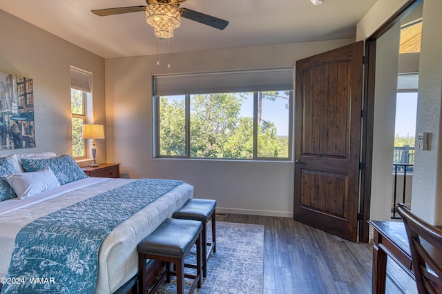 bedroom with a ceiling fan, dark wood-style flooring, a textured wall, and baseboards