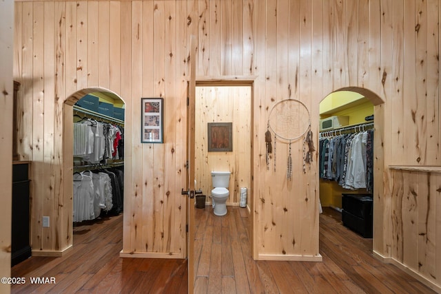 4683 Eagle Nest Ct, Lakeside, AZ 85929 - bedroom with a closet, a spacious closet, arched walkways, hardwood / wood-style flooring, and wood walls
