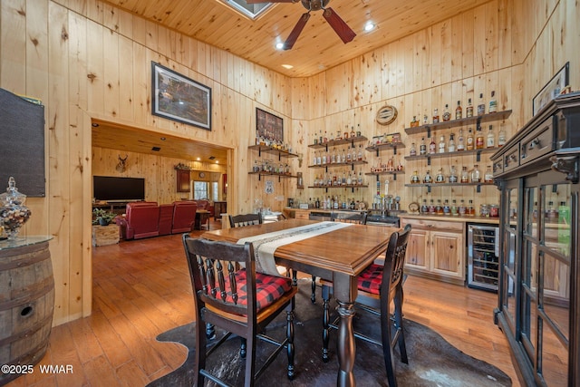 4683 Eagle Nest Ct, Lakeside, AZ 85929 - dining area featuring wine cooler, wood ceiling, bar area, ceiling fan, and light wood-style floors