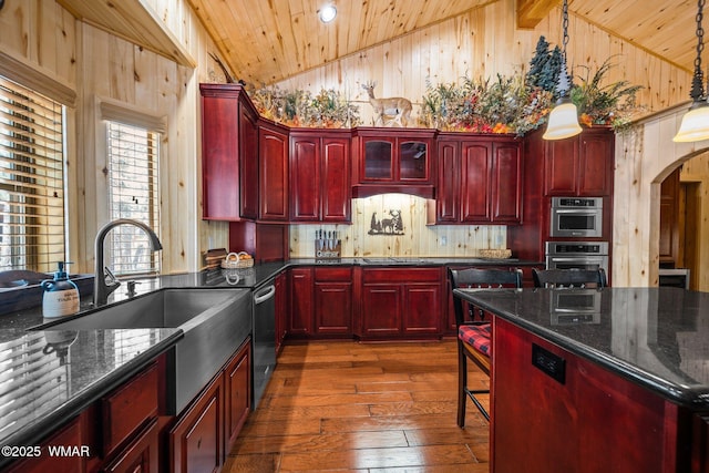 4683 Eagle Nest Ct, Lakeside, AZ 85929 - kitchen with reddish brown cabinets, wooden ceiling, dark wood finished floors, high vaulted ceiling, and wooden walls